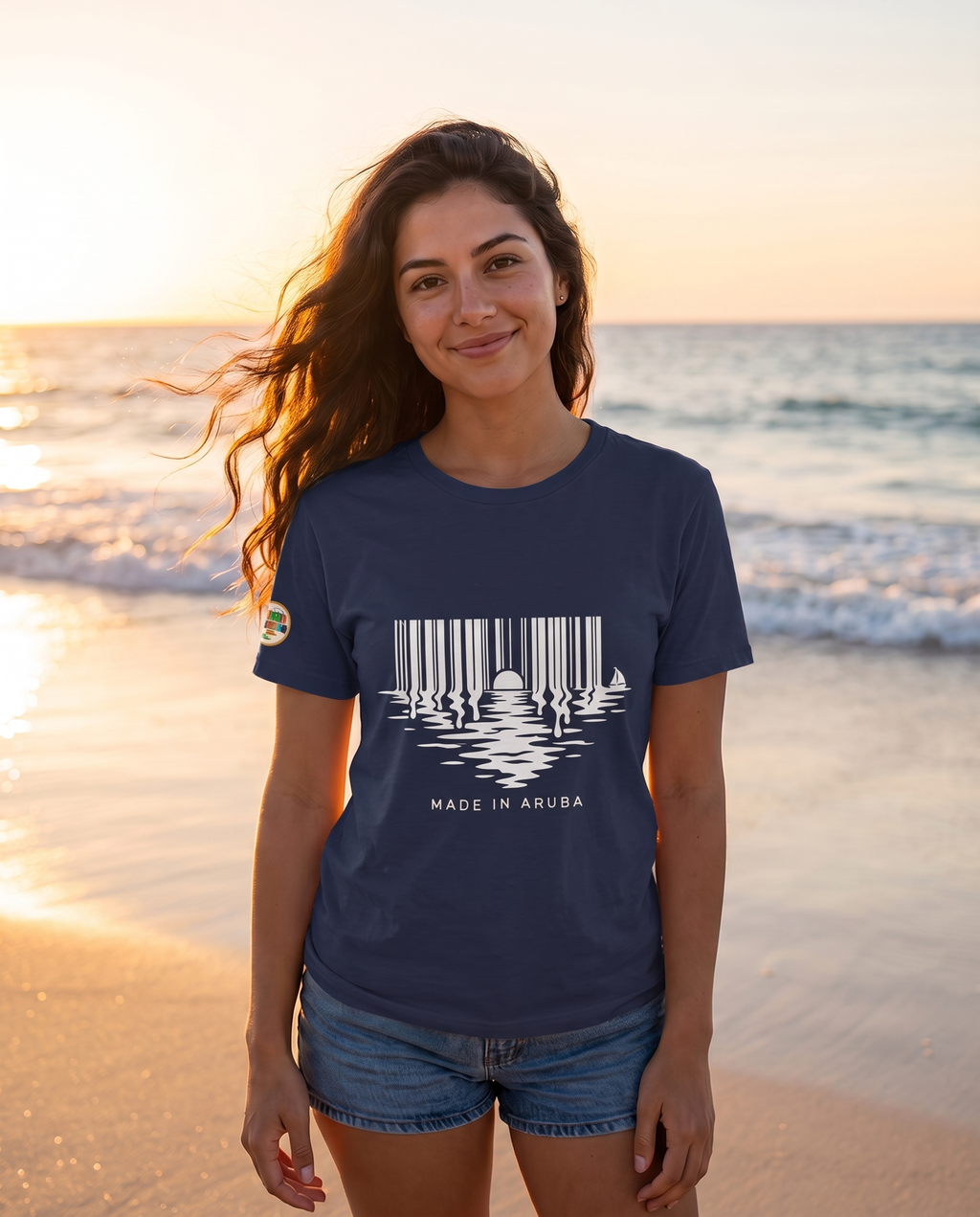 Made in Aruba Barcode Sunset Tee in Navy, worn at golden hour on Eagle Beach, Aruba
