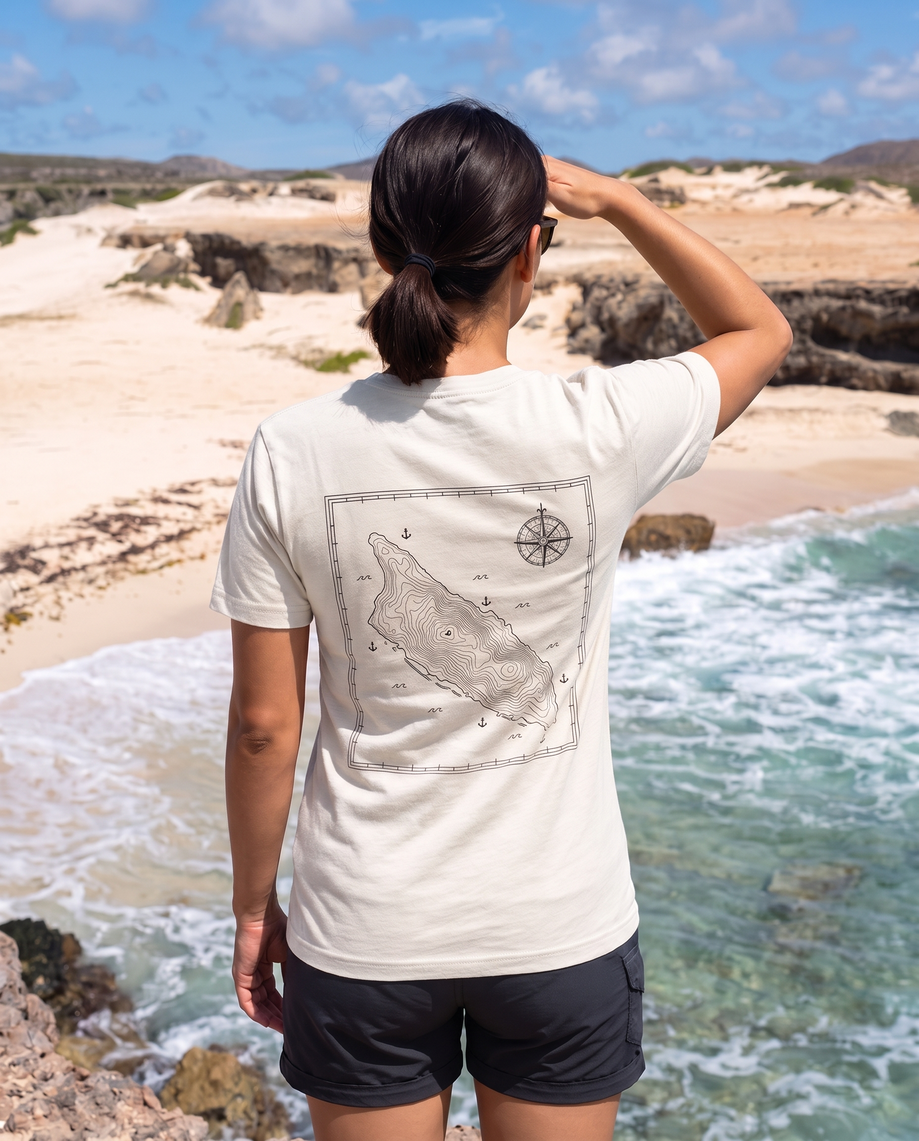 Aruba Topographic Map Tee in Vintage White, worn on the Arikok National Park coast, Aruba (back print)
