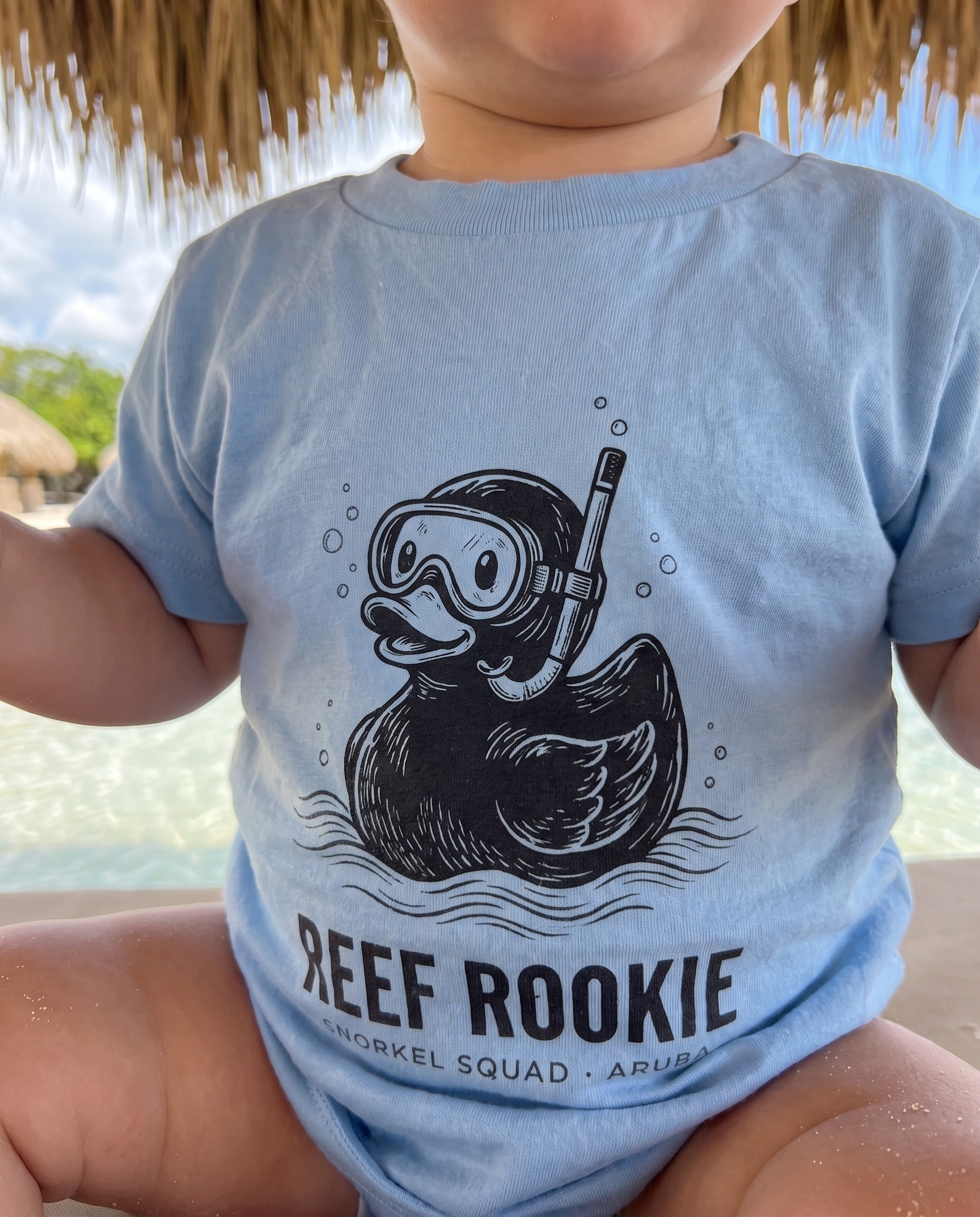 Aruba Reef Rookie Snorkel Duck Baby Tee close-up of the design, Light Blue