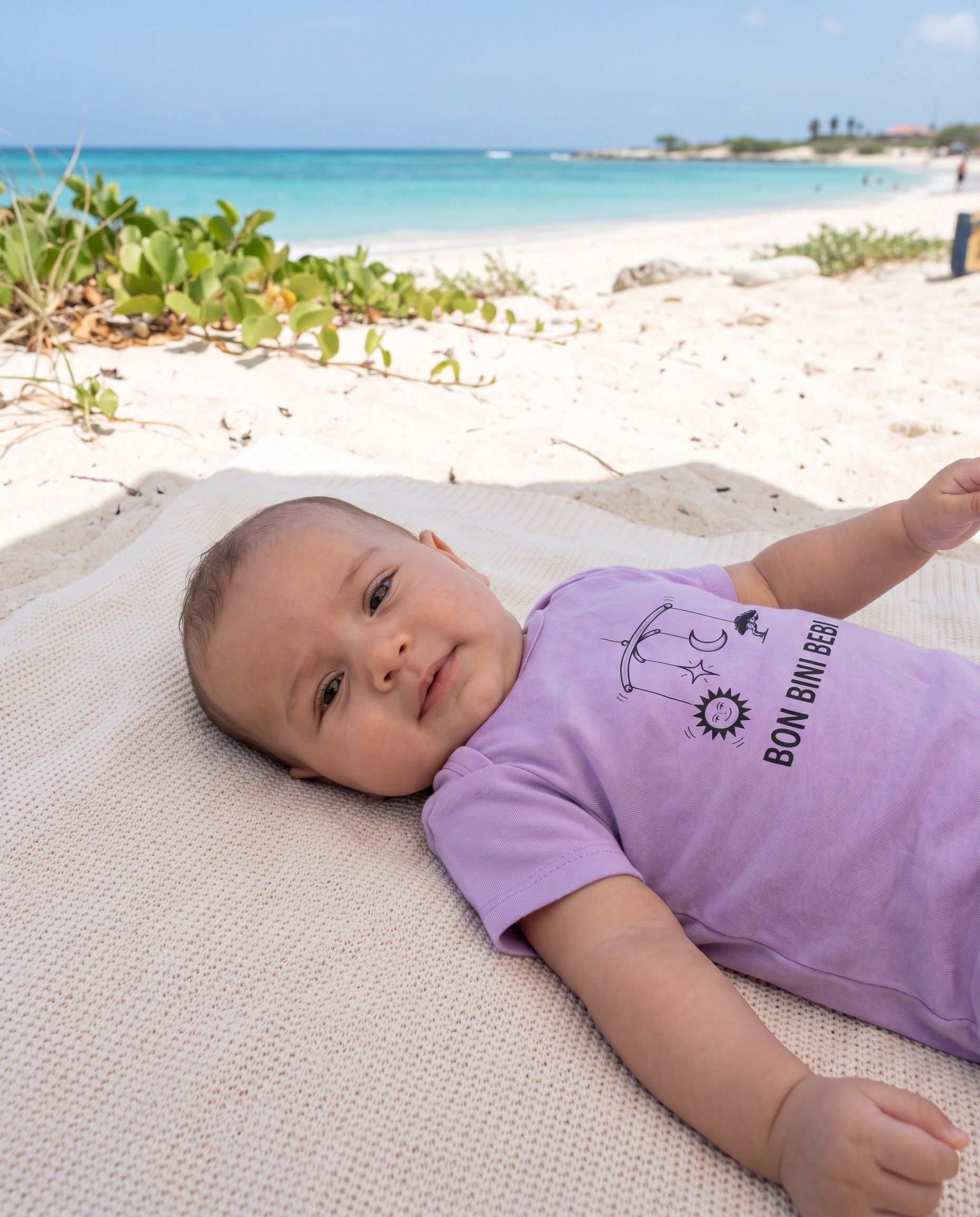 Aruba Bon Bini Bebi Mobile Baby Tee in Lavender, worn on location in Aruba