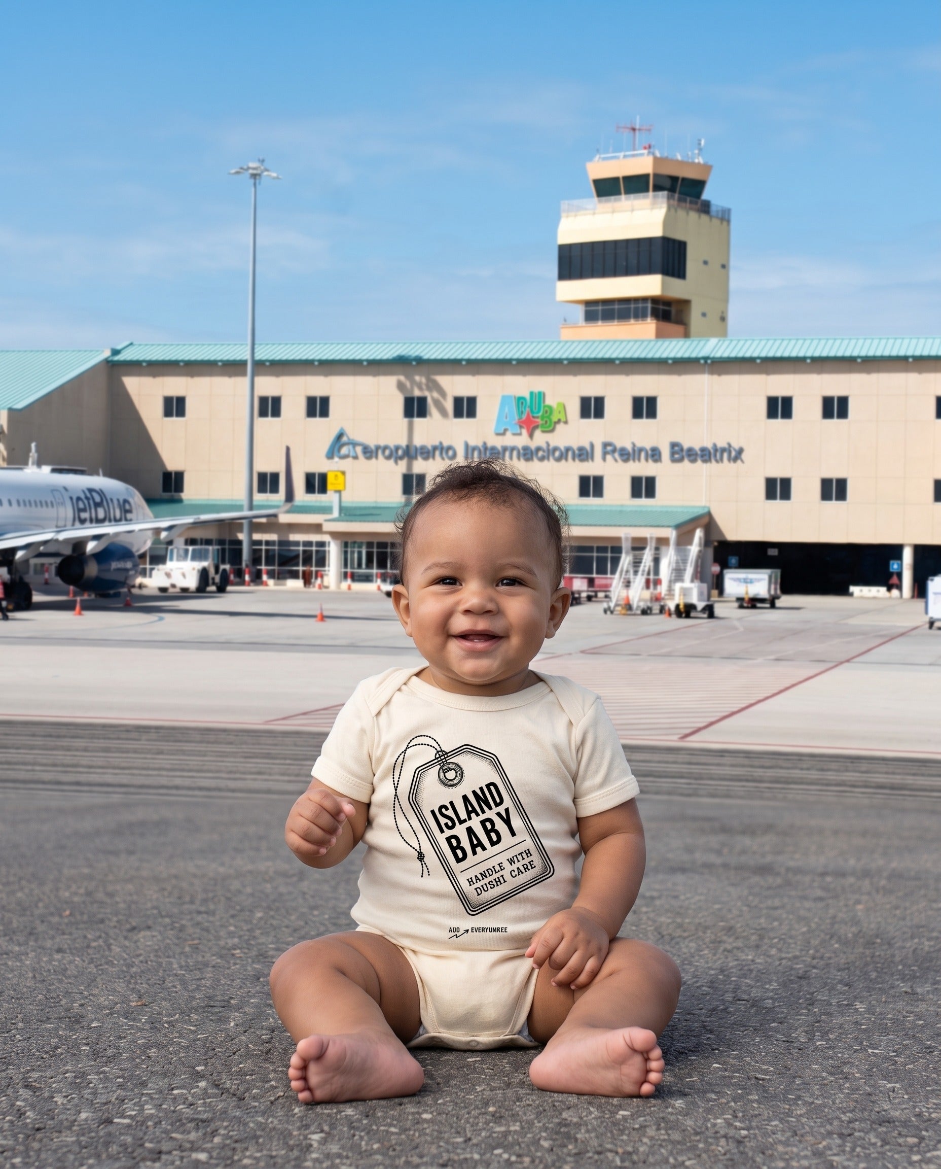 Aruba Island Baby Luggage Tag Bodysuit in Natural, worn on location in Aruba