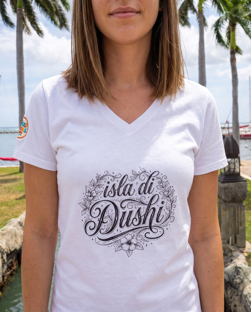 Isla di Dushi Aruba Script V-Neck Tee close-up of the design, Solid White Blend