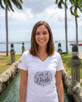 Isla di Dushi Aruba Script V-Neck Tee in Solid White Blend, worn on location in Aruba