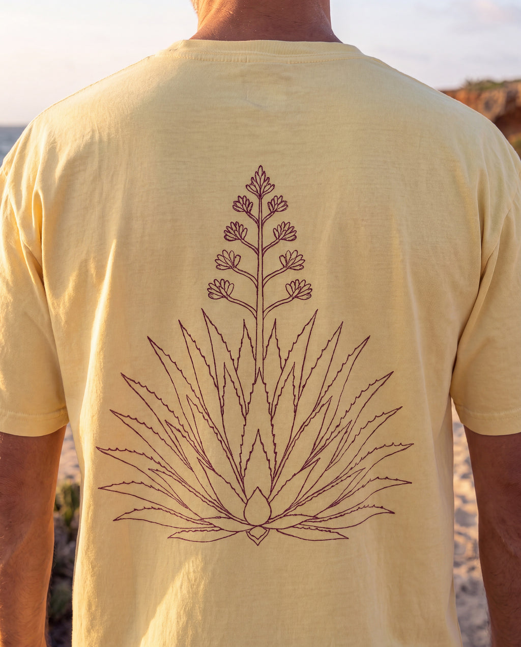 Aruba Agave Crest Redwork Tee close-up of the design, Butter