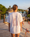 Aruba Flamingo in Reeds Redwork Tee in White, worn on location in Aruba