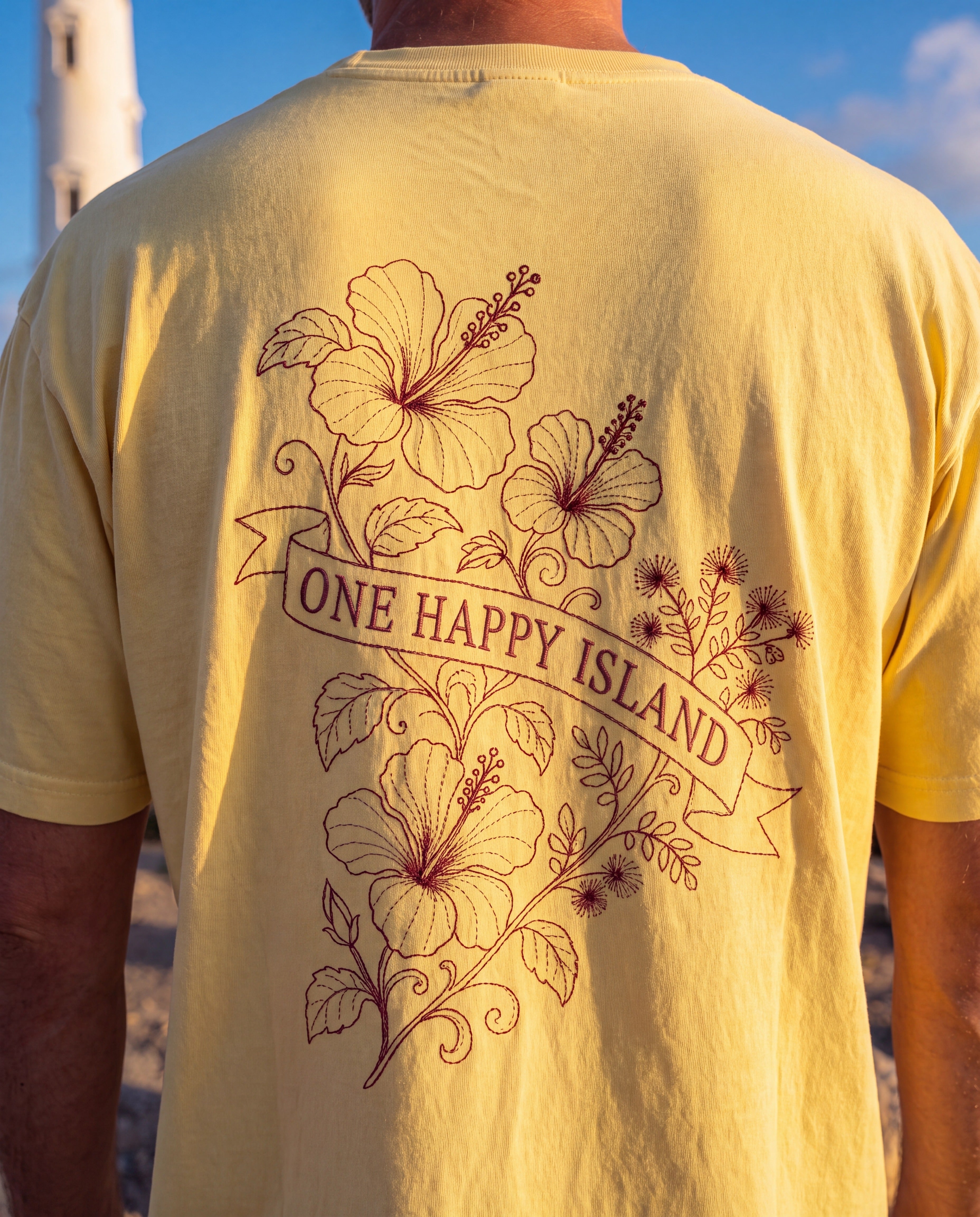 Aruba One Happy Island Banner Redwork Tee close-up of the design, Butter