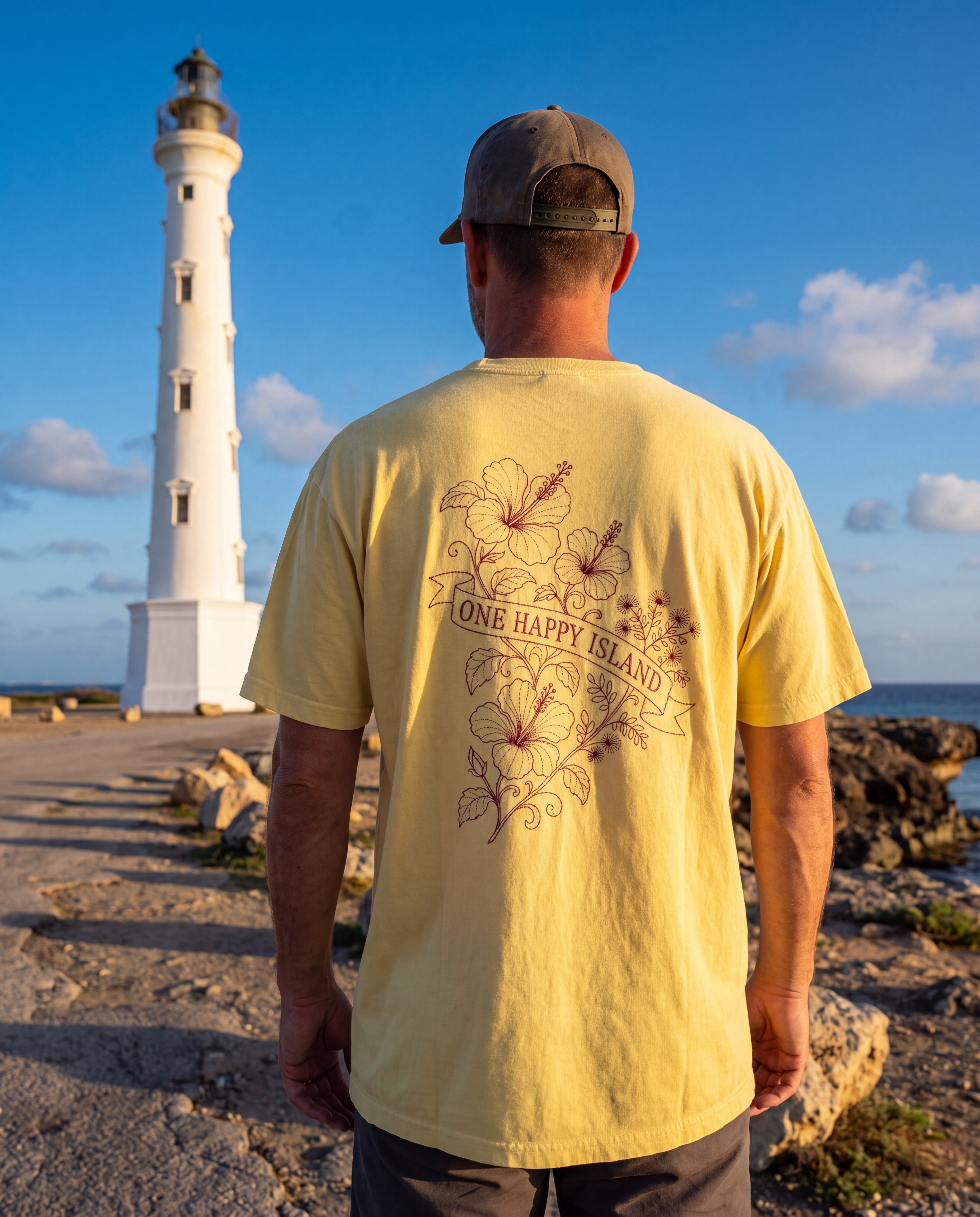 Aruba One Happy Island Banner Redwork Tee in Butter, worn on location in Aruba